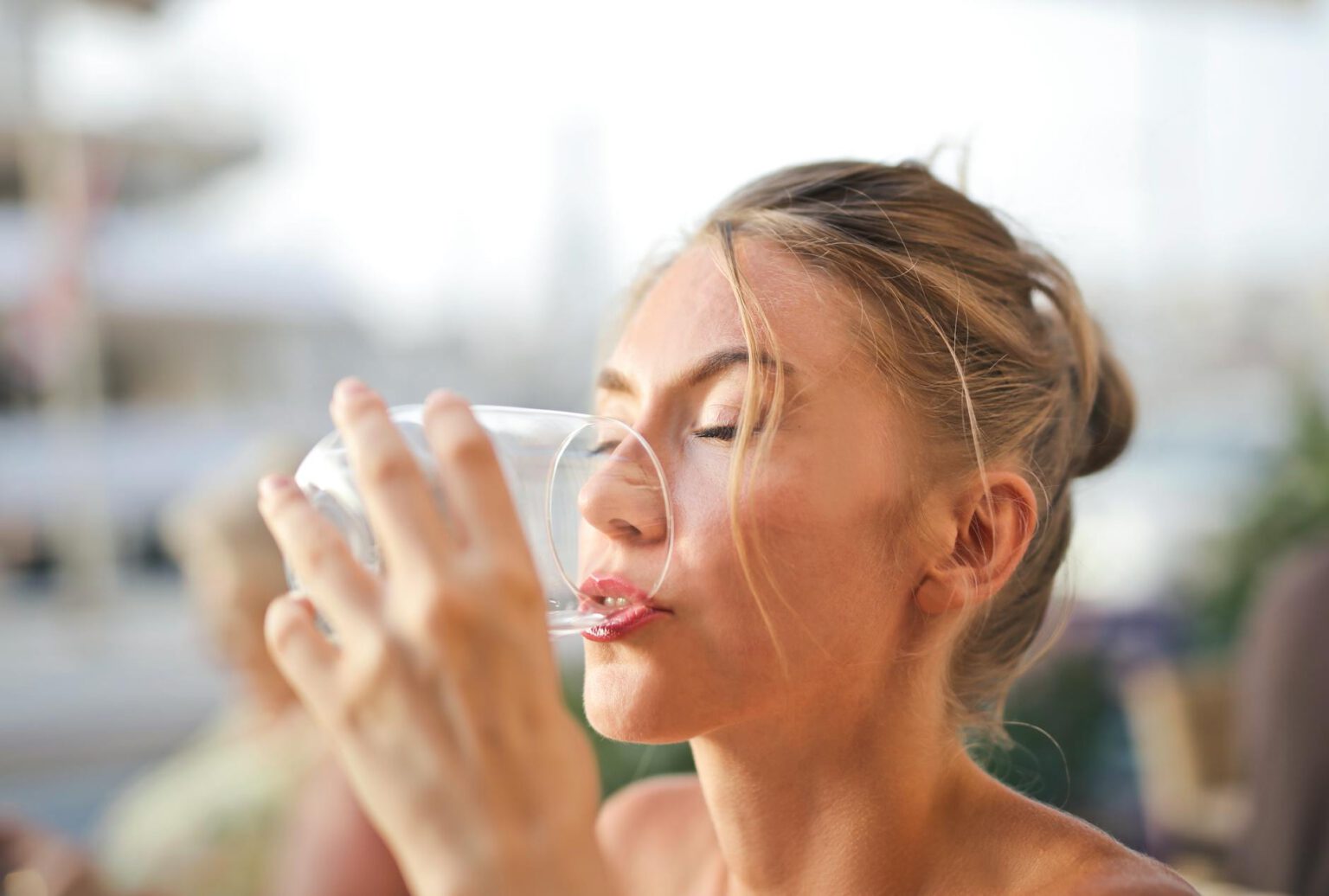 woman drinking from glass